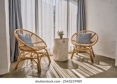 Front view of two wicker chairs and a log coffee table
