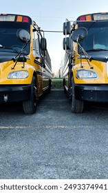 Front view of two yellow school buses.