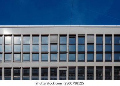 Front view typical modern facade with repetition of rectangular windows be arranged on grid system facade. 