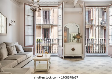 Front View To The Vintage Style Living Room With Sofa, Tile Floor, Retro Lamps And Balconies. Refurbished Apartment In Barcelona Old City