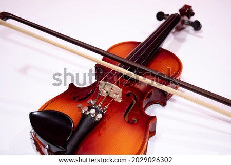 Front view of violin with fiddlesticks isolated on white background