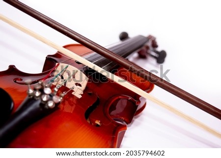 Front view of violin with fiddlesticks isolated on white background