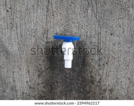 Front view of the water faucet with a cement wall texture background. bathroom background concept, interior, pipes, water channels, ablution place, flowing, household, hygiene, liquid, sink, wet