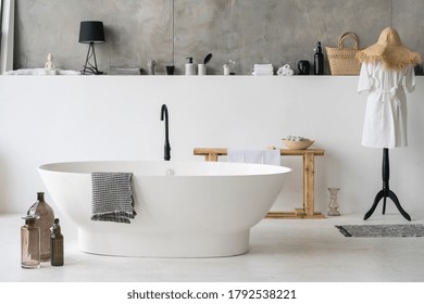 Front View Of White Modern Bath In Contemporary Apartment With Stylish Loft Interior Design, House Decor, Cotton Bathrobe And Clean Dry Towels