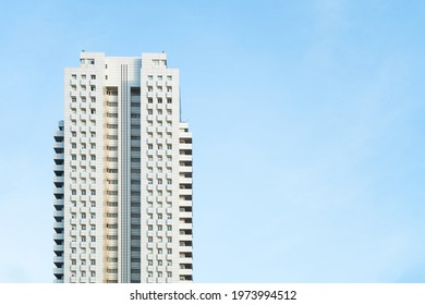 Front view of a white modern skyscraper perfect symmetry with blue sky and copy space. Architecture background concept