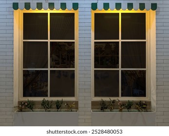 Front view of the window store with a blank window on a white wall background in the shopping mall. Blank window store for copy space of your logo or trademark