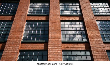 Front View Windows Of A Restored Historic Shoe Warehouse Brick Building, Converted To A Senior Living Apartment.