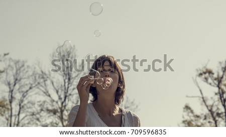 Similar – Young teenage girl blowing pink bubble gum