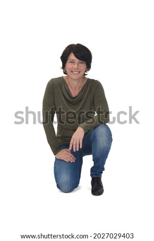 front view of a woman crouching on white background