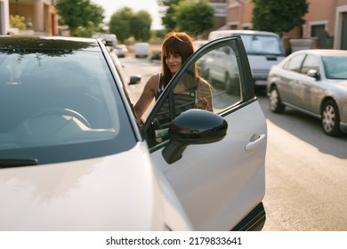 Front View Of A Woman Getting Into A Car