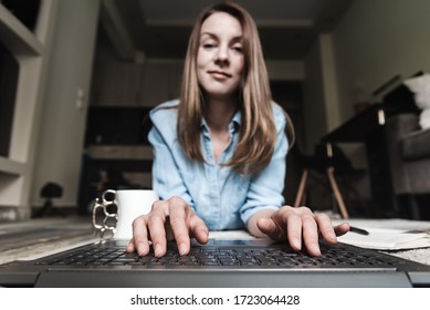 Front View Of Woman Out Of Focus Using Laptop With Hands On Keyboard.