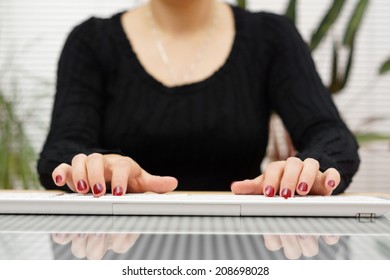 Front View  Woman Is Typing On White  Keyboard At Home