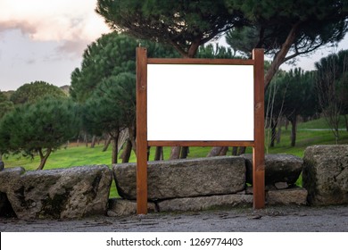 Front View Of A Wooden Advertisement Mockup At A Green Forest Park. Park Indications And Regulations.