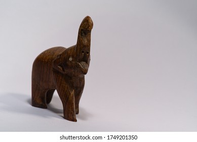 front view of a wooden carved elephant statue with trunk up