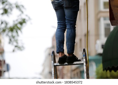 front view worker standing on ladder
