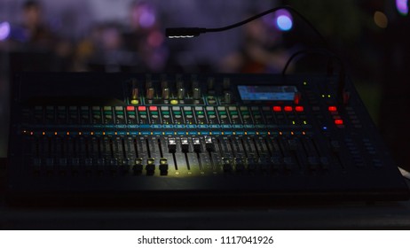 Front view to the working mixing console, an electronic device for changing the volume level, timbre (tone color) of many different audio signals