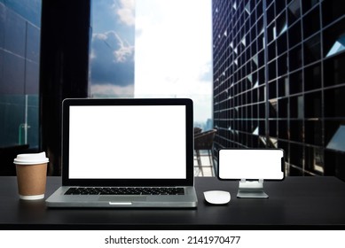Front view workspace with computer, smartphone and tablet on white desk with blurred background as concept at modern office