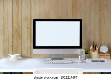 Front view workspace mockup desk with desktop computer and office supplies. Blank screen monitor for graphic display montage. - Shutterstock ID 1022217697