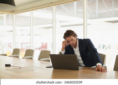 Front view of worried young Caucasian businessman using laptop in the conference room at office. New start-up business with entrepreneur working hard - Shutterstock ID 1465023539