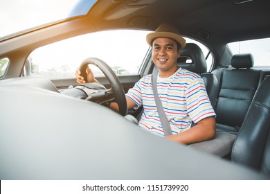 Front View Of Young Asian Man Driving Car.