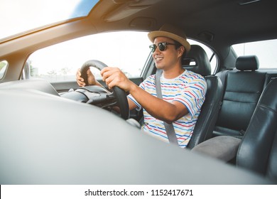 Front View Of Young Asian Man Driving Car.