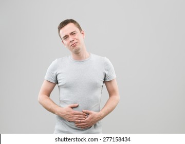 Front View Of Young Caucasian Man With Upset Stomach