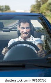 Front View Of A Young Man Driving His Convertible Car