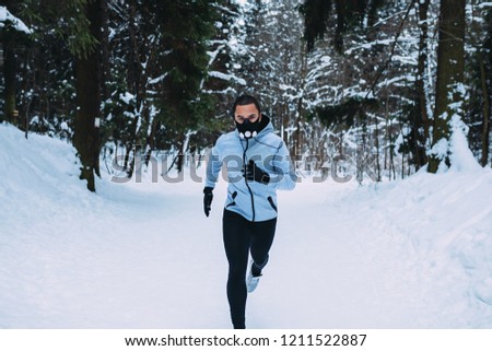 Similar – Young man running outdoors during workout in a forest