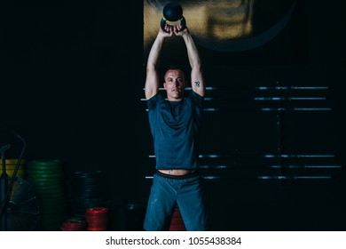 Front View Of A Young Sporty Man Doing Kettlebell Swing Exercise On A Fitness Routine At The Box Gym