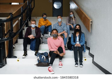 Front View Of Young Students With Face Masks Back At College Or University, Coronavirus Concept.