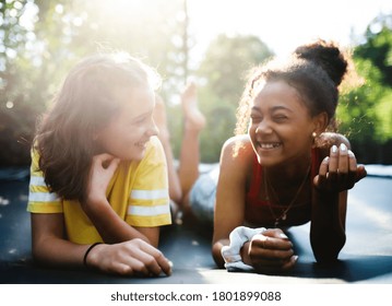 Front View Of Young Teenager Girls Friends Outdoors In Garden, Laughing.