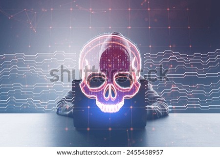 Front viw of hacker at desk using laptop with creative skull and circuit hologram on blurry background. Malware and ransomware concept