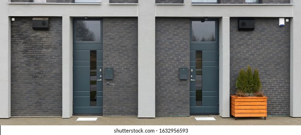 Front  Wall Of A Mass Production Standard Low Cost  Unfinished Residential Building With Armed Doors And  Windows. Natural Colors Simplistic  Image