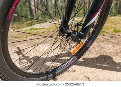 Front wheel of a bicycle, highlighting the disc brake system. Disc brakes offer excellent braking performance, especially in wet or muddy conditions. Spokes and rim. - Powered by Shutterstock