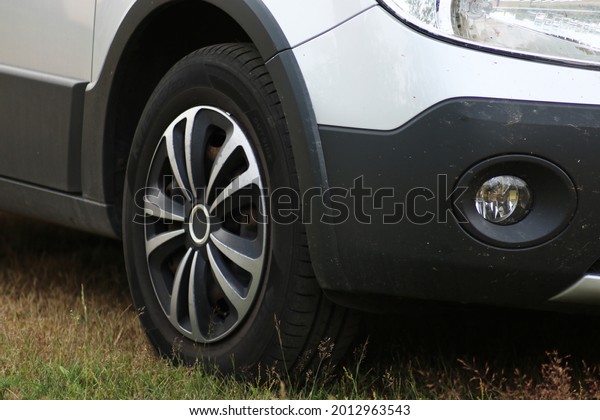 Front wheel of a passenger car close-up.\
Automotive wheel caps. Car\
tuning.