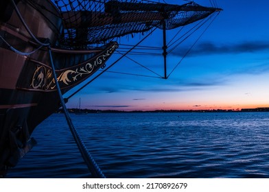 Front Of Wooden Ship With Sunset Background. Ship Bow With Ocean Sunset. Pirate Ship Exterior Docked On Boat Dock. Abstract Nature. Minimal Industrial Design. 