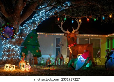 Front yard with brightly illuminated christmas decorations. Outside decor of florida family home for winter holidays - Powered by Shutterstock