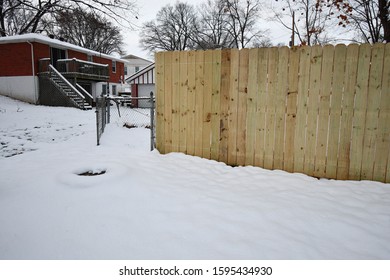 A Front Yard Covered In Snow Following A Blizzard In Kansas City, Missouri. There Are Different Kinds Of Fences Up In The Neighborhood.