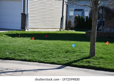 A Front Yard With Utility Flags In It. The Neighborhood Is In St. Peters, Missouri. Picture Taken On March 27th, 2021.