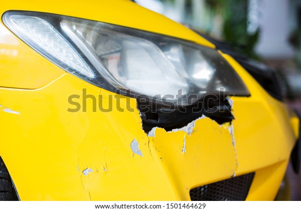 Front of\
yellow car get damaged by accident on the road. Yellow car crash\
accident, damaged automobiles after\
collision.
