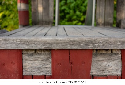 Frontal Closeup Of A Wooden Climbing Frame In A Children's Playground. Front View Without People. Wood. Table Edge. Blurred Background With Slide.