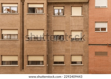 Frontal image of a Facade of a building with windows of various formats