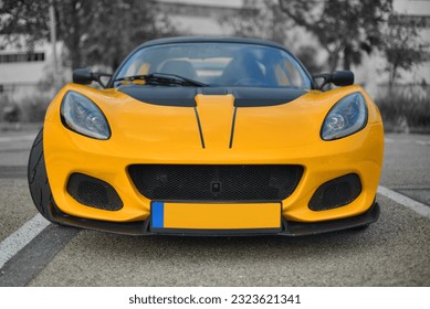 A frontal photo of a British yellow roadster  - Shutterstock ID 2323621341