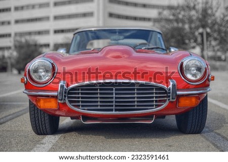 Frontal photo of a classic British red car 