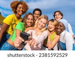 Frontal photo of a multi-ethnic friends taking a selfie with a gopro camera