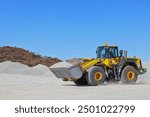 Front-end loader (bucket, payloader, high lift, shovel dozer, skid-steer, skip) moving ore, mine, Outback Western Australia