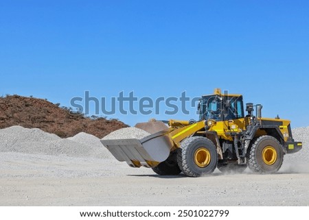Front-end loader (bucket, payloader, high lift, shovel dozer, skid-steer, skip) moving ore, mine, Outback Western Australia