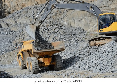 a frontend loader loading dolerite onto a tip truck 