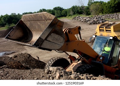 Frontend Loader Moving Dirt From A Hill For Construction