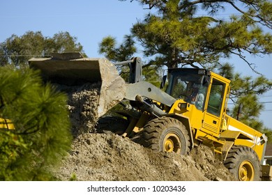 A front-end loader at work moving dirt